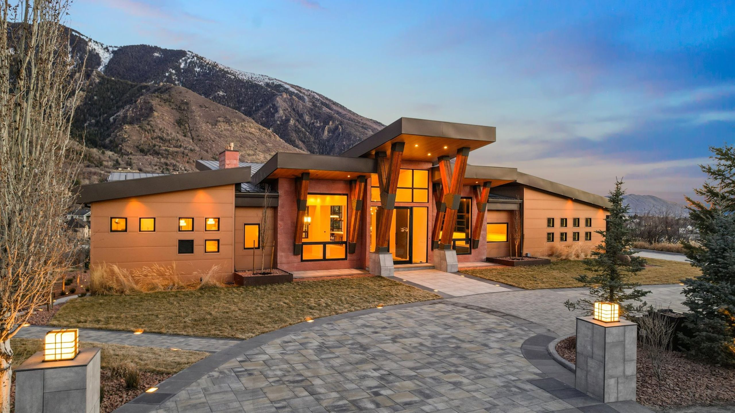 Contemporary house featuring a mountain view, standing seam roof, and stucco siding